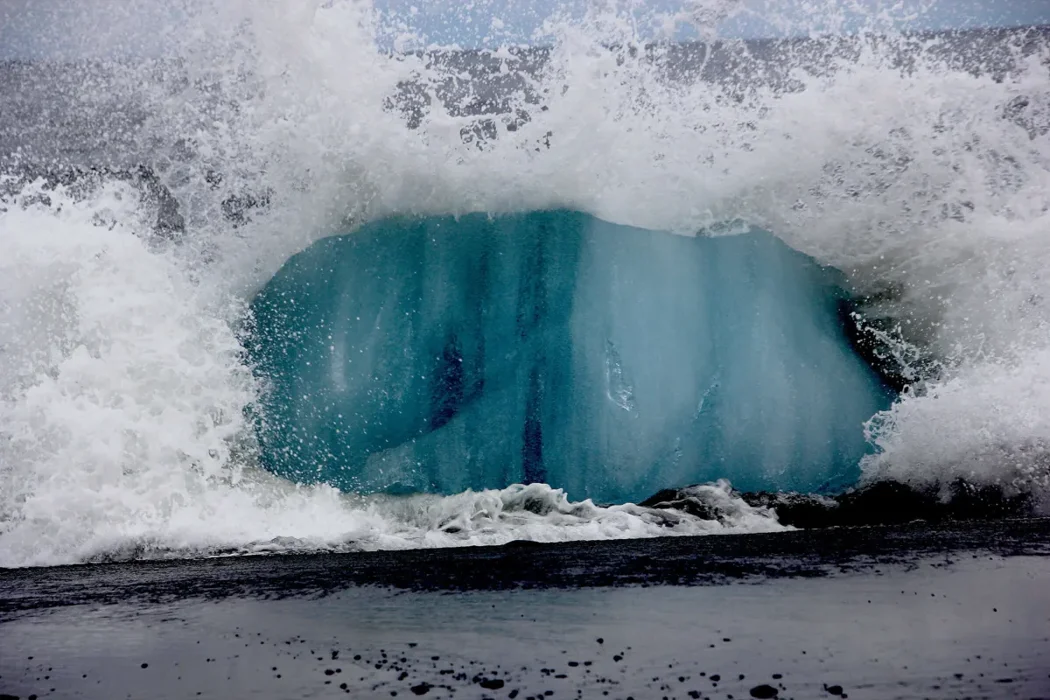 Iceberg crashing into the sea
